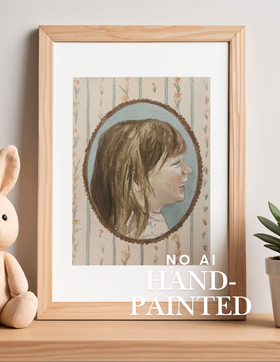 A framed vintage-style portrait print leaning on a wooden surface, with a plush bunny on the left and a small plant on the right. The print shows a side-profile portrait of a woman inside an oval frame, with the text 'NO AI HAND-PAINTED' overlaid at the bottom.