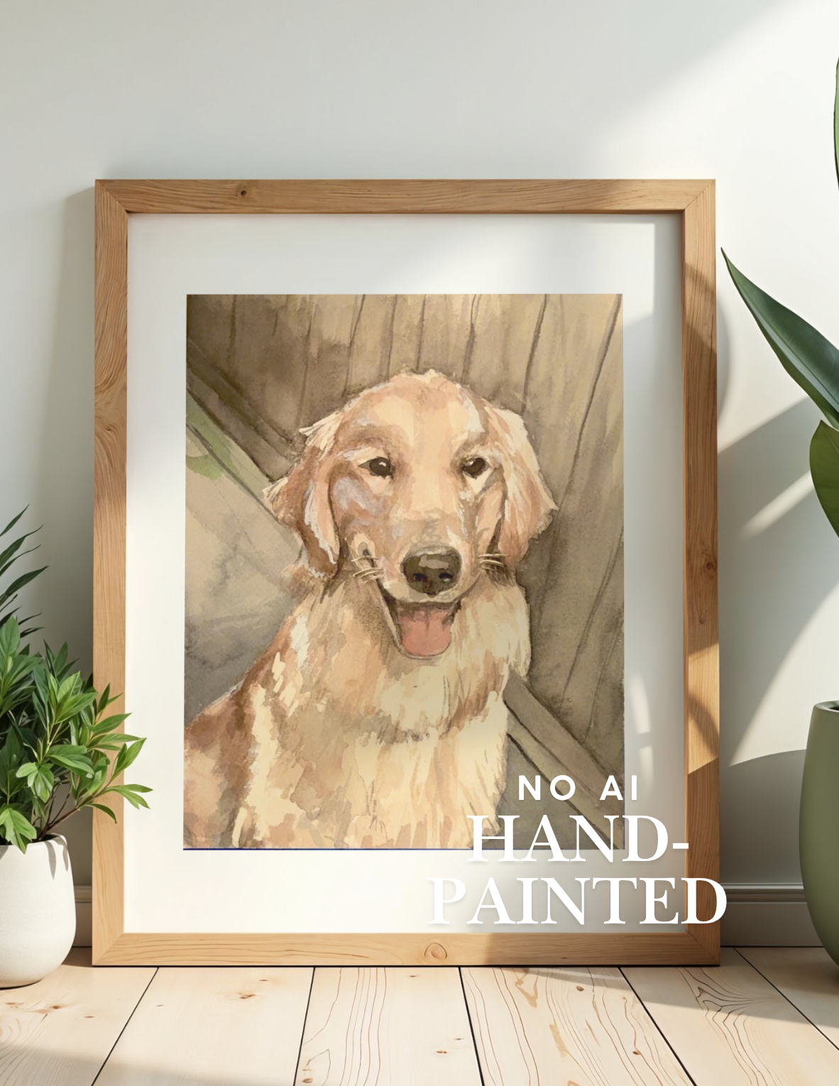A framed watercolor-style portrait print of a golden retriever dog, displayed leaning against a wall on a light wood floor with potted plants on both sides. The print includes the text 'NO AI HAND-PAINTED' in white at the lower right.