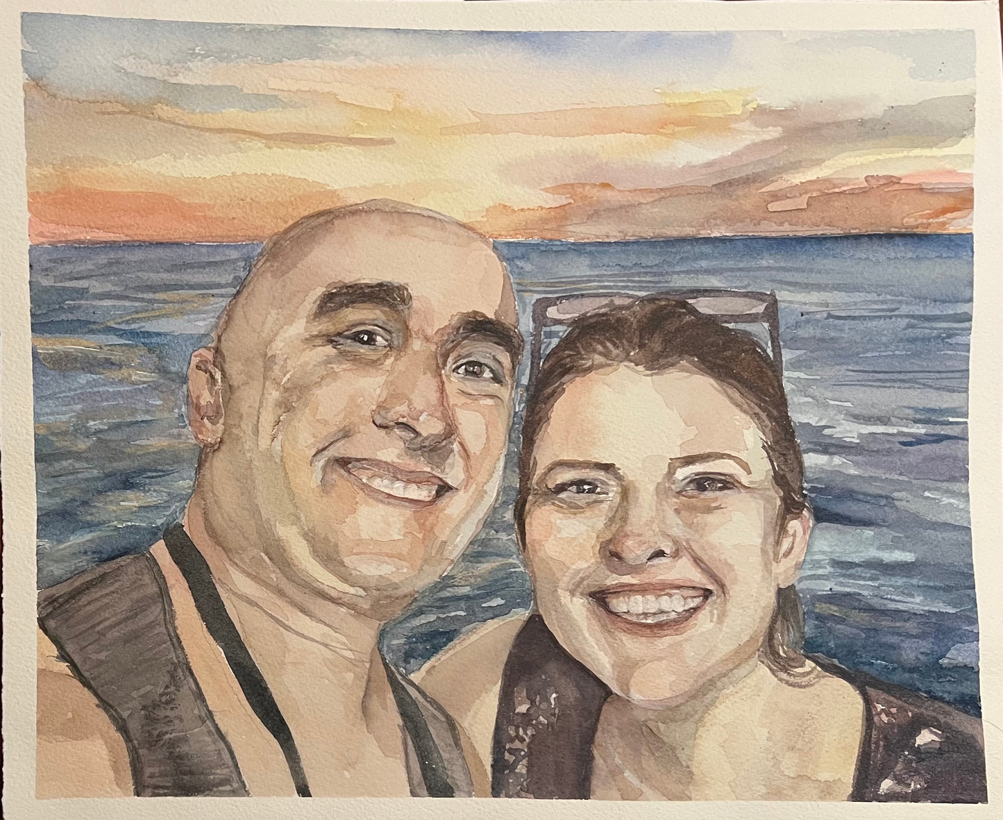 watercolor painting with two adults smiling by the ocean at a sunset