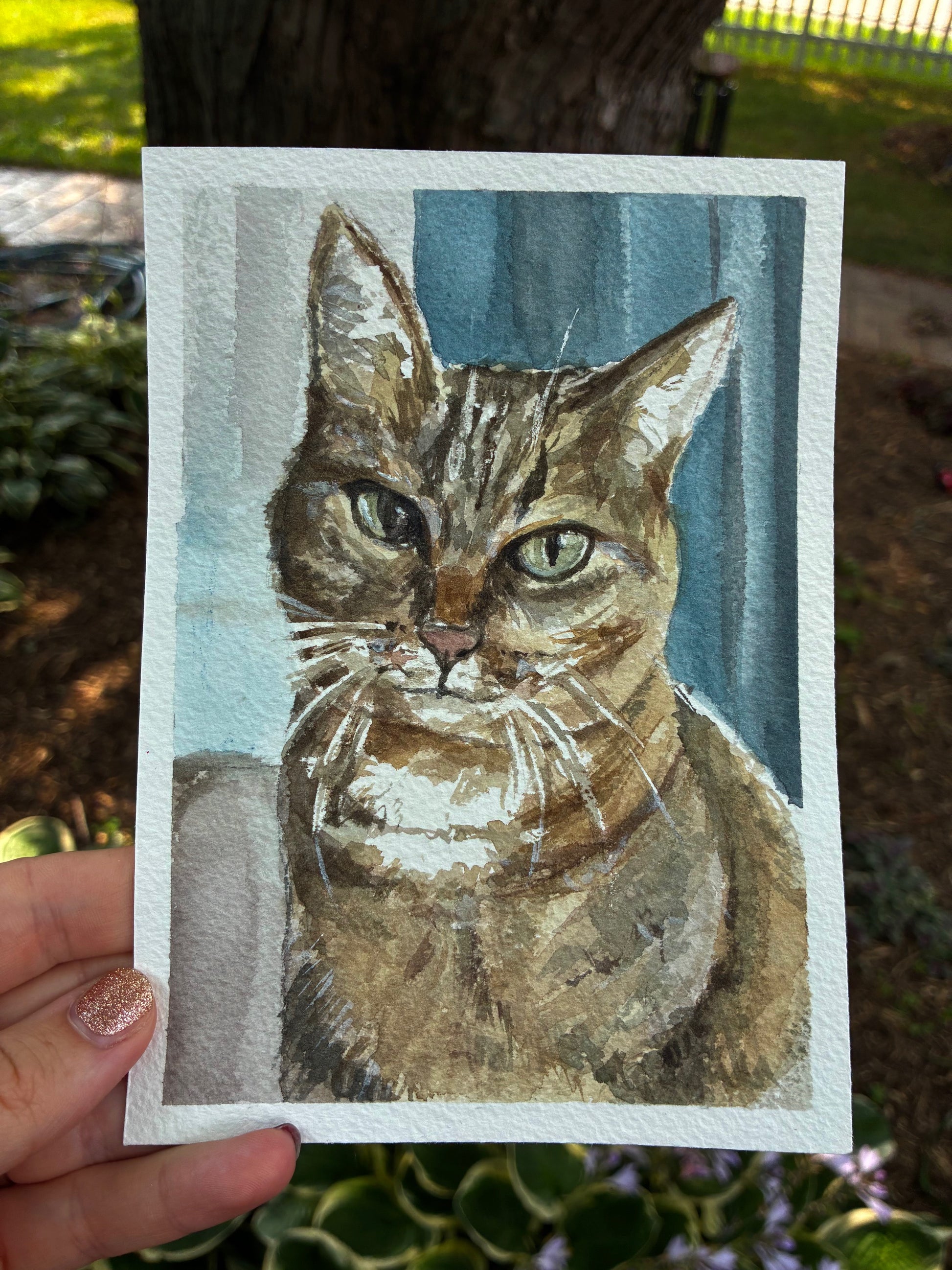 This is a watercolor painting with a cat with a blue background