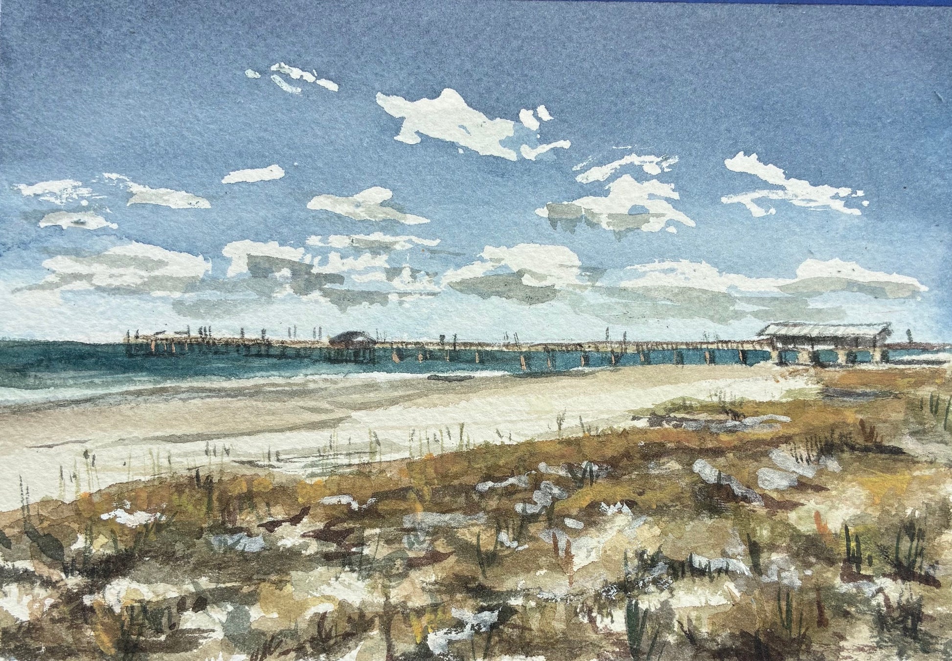 this watercolor painting is a beach with a pier and clouds in a blue sky 