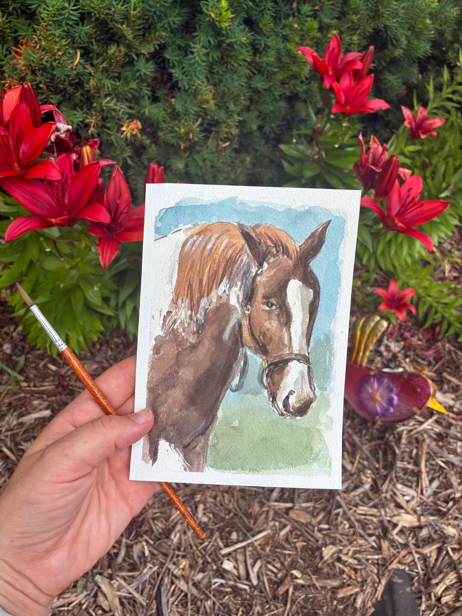 This is a watercolor painting of a horse, set infront of flowers